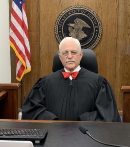 former immigration Judge Elliott Kaplan